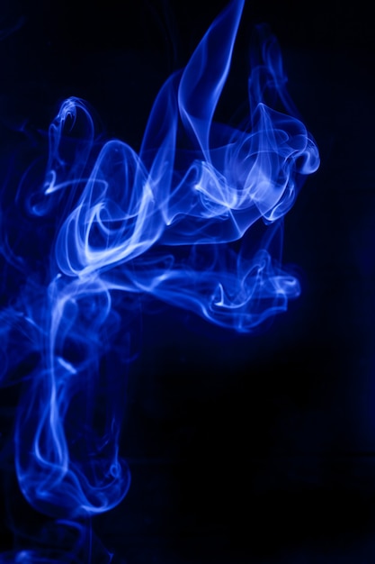 Blue smoke on a black background.