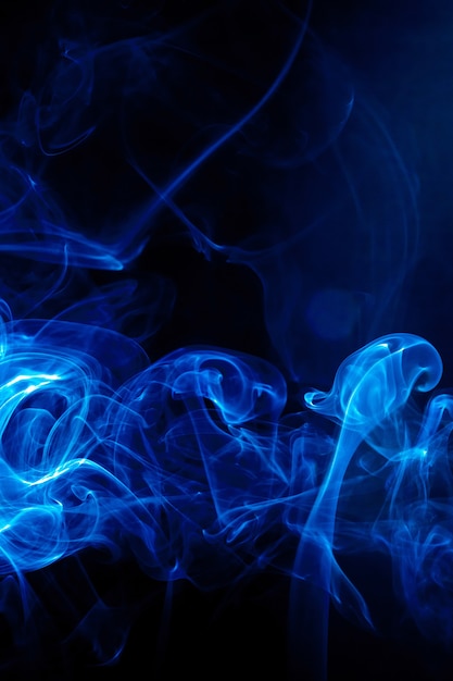 Photo blue smoke motion on black background.