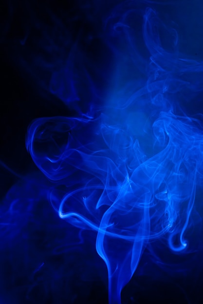 Blue smoke motion on black surface.