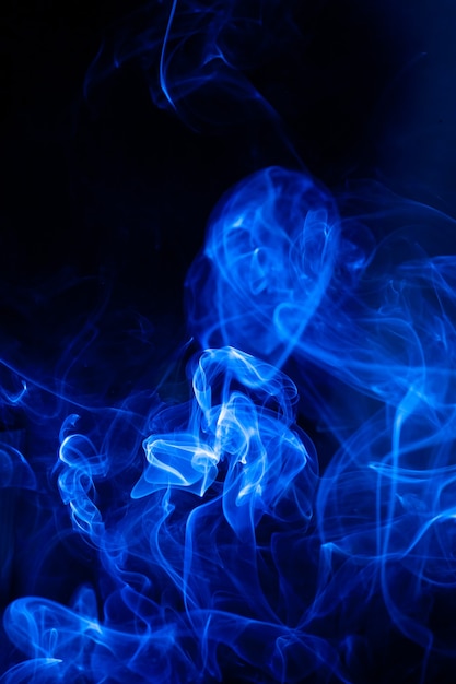 Blue smoke motion on black surface.