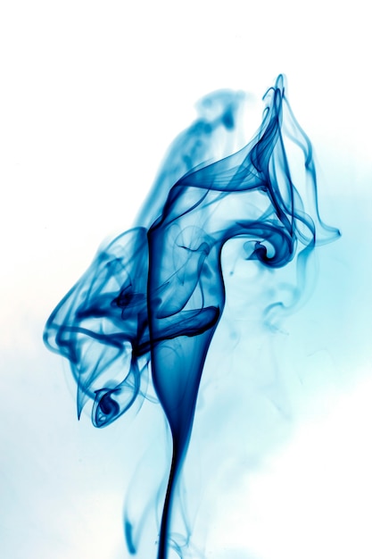 Photo blue smoke movement on white background.
