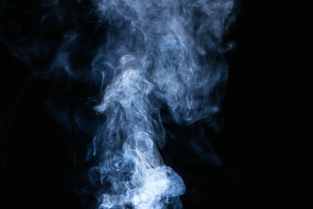 Photo blue smoke waves on black background