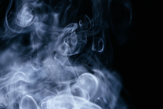 Blue smoke waves on black background