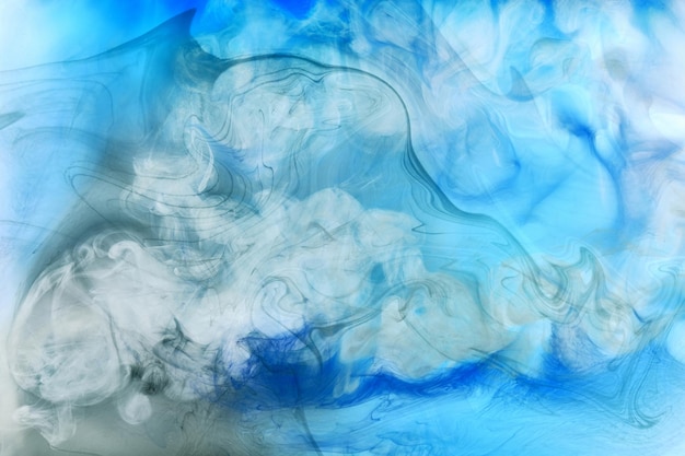 Blue smoke on white ink background, colorful fog, abstract swirling ocean sea, acrylic paint pigment underwater