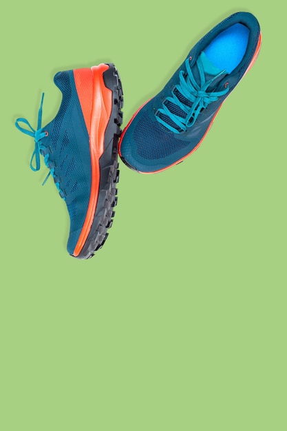 Photo blue sneakers on a  green background