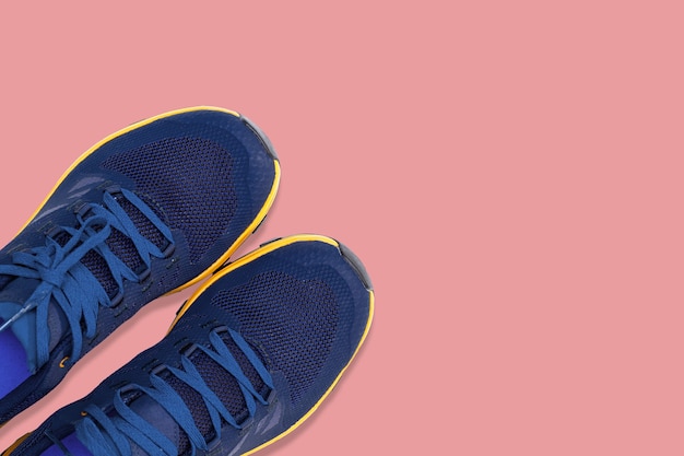 Blue sneakers on a  pink background