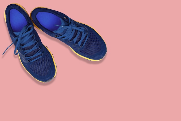 Blue sneakers on a  pink background