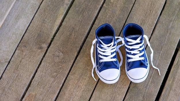 Blue sneakers on wooden boards