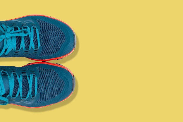 Blue sneakers on a yellow background