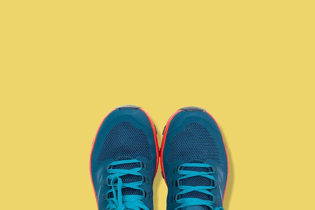 Blue sneakers on a yellow background