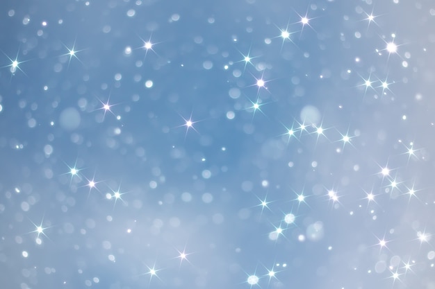 Blue snowfall bokeh background, abstract snowflake background blurred abstract blue