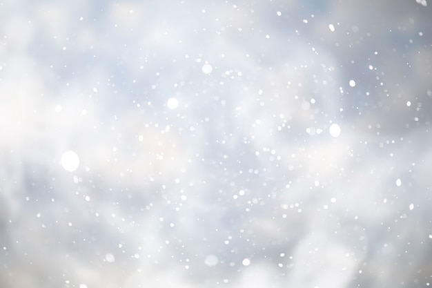 Blue snowfall bokeh background, abstract snowflake background blurred abstract blue