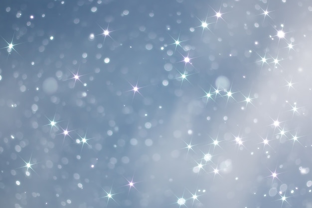 Blue snowfall bokeh background, abstract snowflake background blurred abstract blue