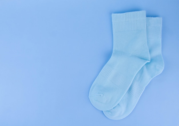 Photo blue socks. blue socks on a blue background. socks on a colored background