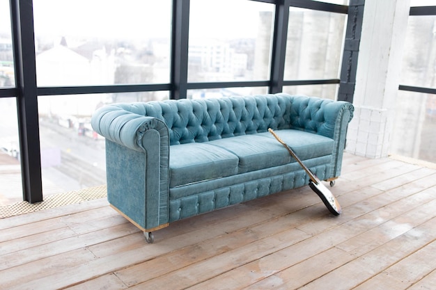 blue sofa in a large room with panoramic windows