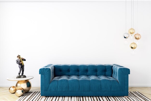 A blue sofa in a living room with a white wall and a gold lamp.