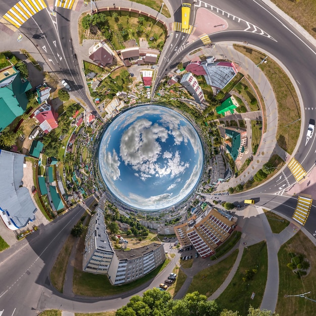 Blue sphere inside overlooking old town urban development historic buildings and crossroads with cars Transformation of spherical 360 panorama in abstract aerial view