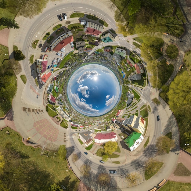 Blue sphere inside overlooking old town urban development historic buildings and crossroads with cars Transformation of spherical 360 panorama in abstract aerial view