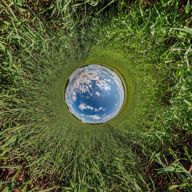 Blue sphere little planet inside gravel road or field background