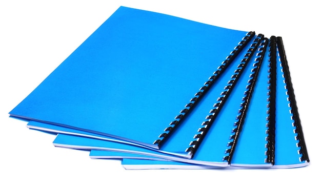 Photo blue spiral bound note books over white