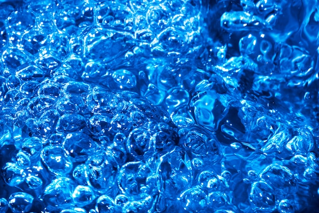 Blue splash and ripples on the stream water 