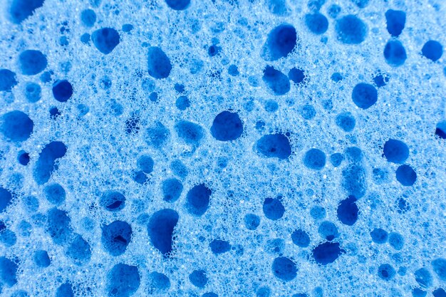 Blue sponge texture background. Close up, macro photo.