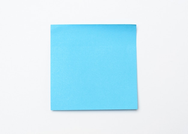 Blue square sticker on white surface copy space