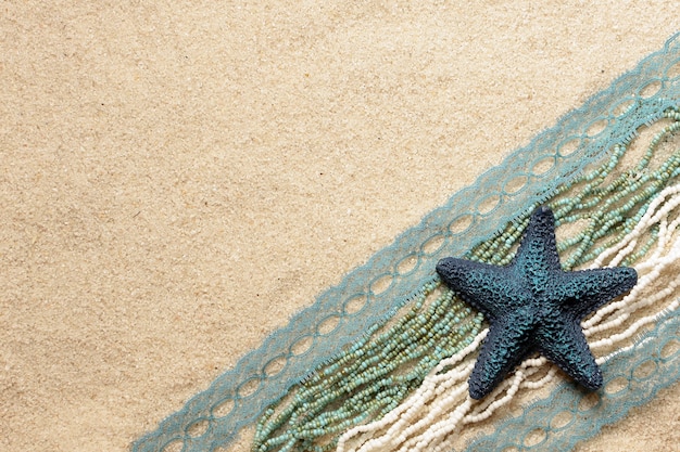 Blue starfish on the bright sea sand for cards