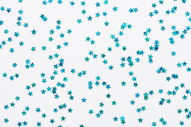 Blue stars glitter confetti on white background