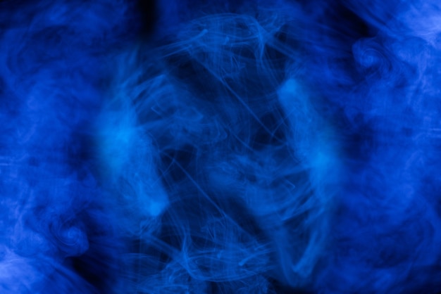 Blue steam on a black background. Copy space.