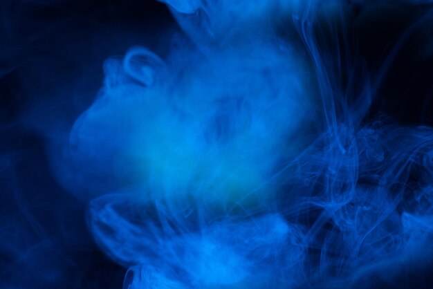 Premium Photo  Blue steam on a black background. copy space.