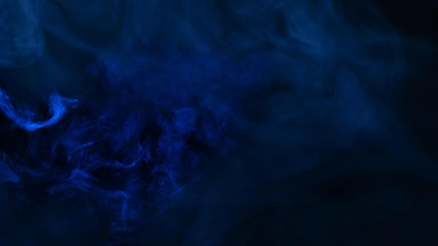 Blue steam on a black background. Copy space.