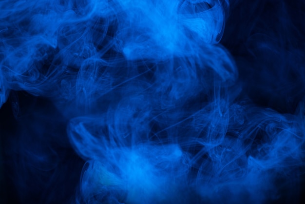 Premium Photo  Blue steam on a black background. copy space.