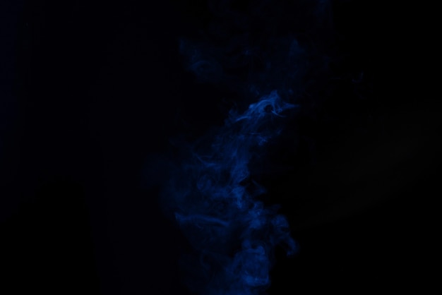 Blue steam on a black background. Copy space.