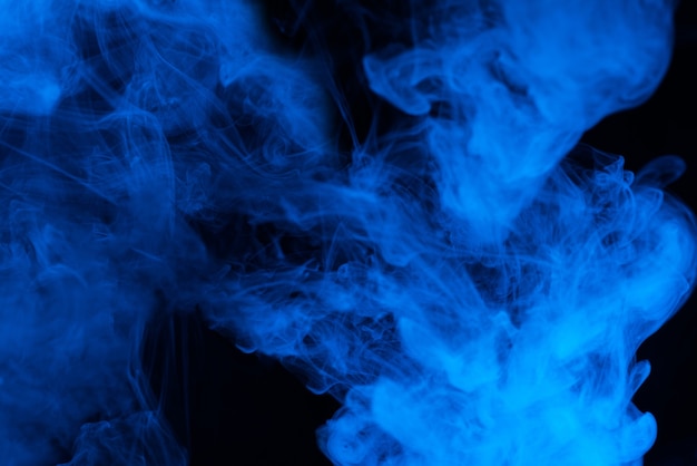 Photo blue steam on a black background. copy space.