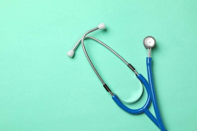 Blue stethoscope on mint surface