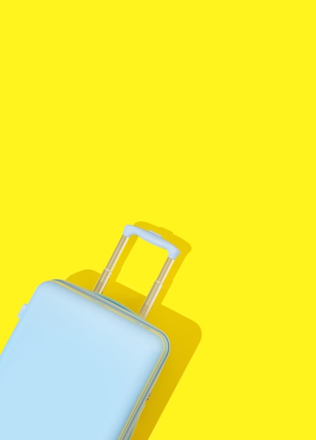 Blue suitcase on a yellow background with long deep shadows travel concept minimal style