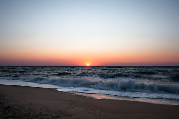 Blue sunrise on the sea coast.