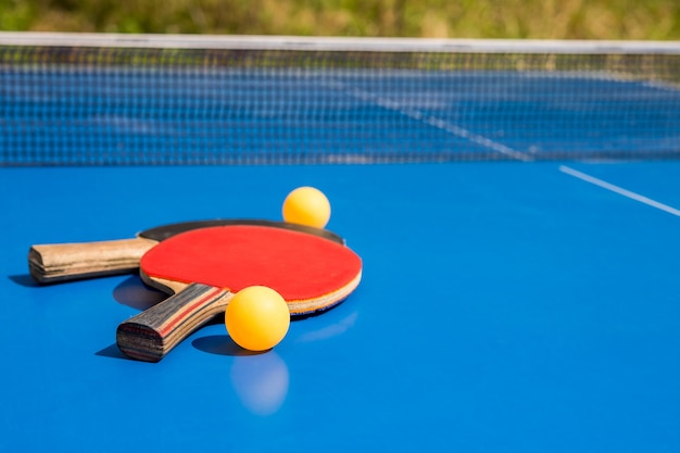 Blue table tennis or ping pong Outdoor tablet tennis Closeup pingpong Accessories for table tennis racket and ball on a blue tennis table Sport