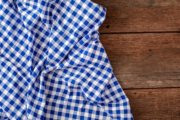 Blue tablecloth on wooden background