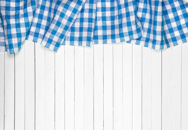 Blue tablecloth on wooden table, top view