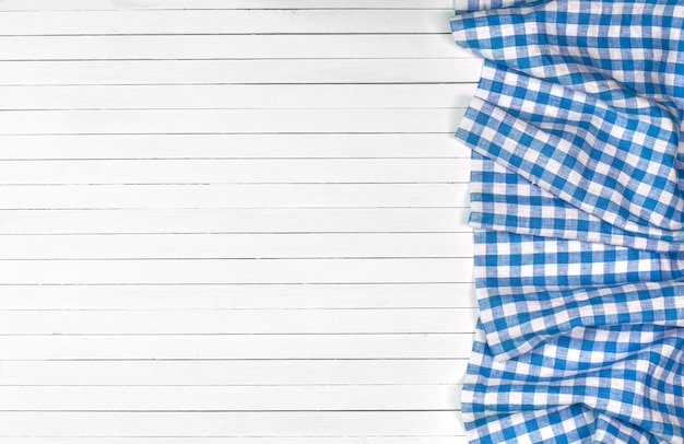 Blue tablecloth on wooden table top view