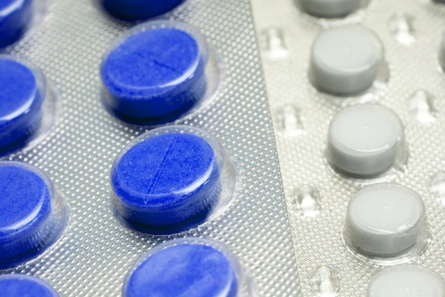 Blue tablets in a close-up blister. medical drugs