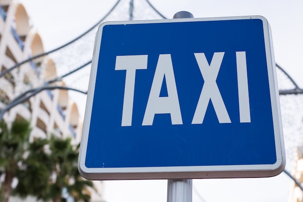 Blue taxi sign in the city centre