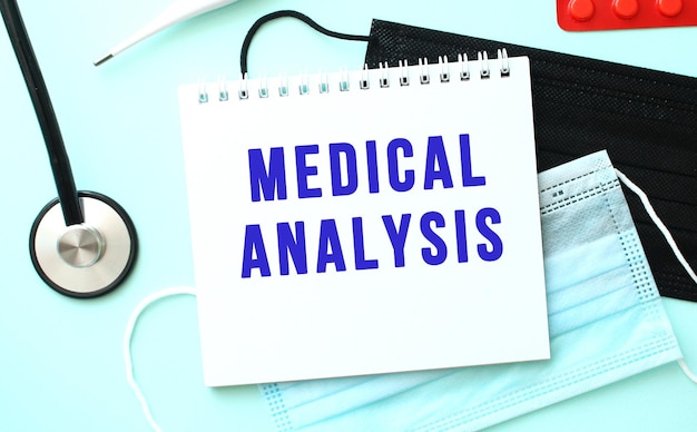 The blue text medical analysis is written in a notebook that lies on a blue background