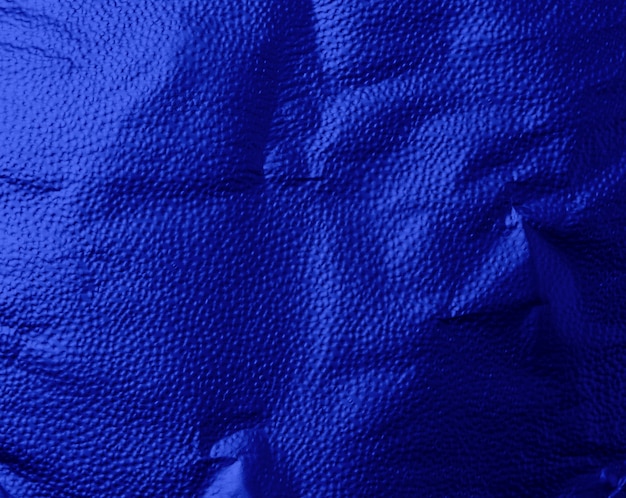 Blue texture of crumpled sheet of foil, full frame