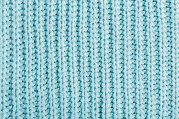 Blue texture of a large knit sweater. knitted scarf background, winter cozy textile background