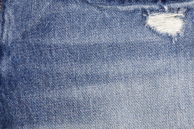 Blue torn denim jeans texture.