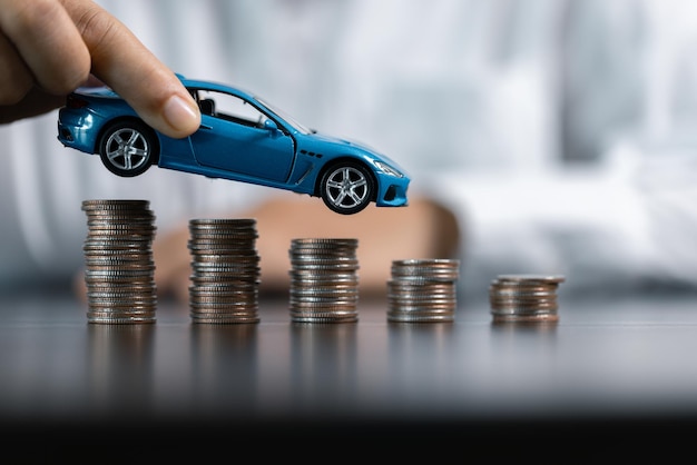 blue toy car in front of businessman calculating loan saving money for car concept trade car for cash concept finance concept