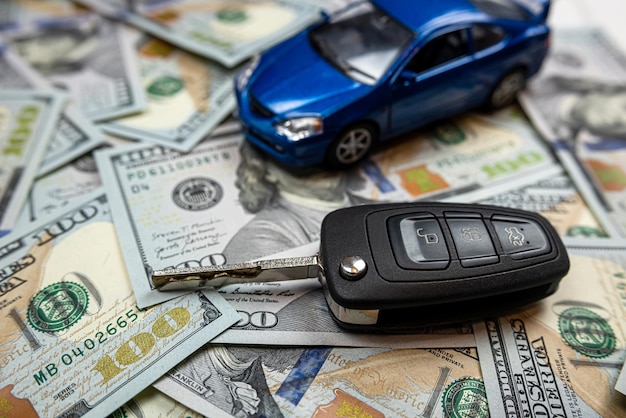 Photo blue toy car with key over us money